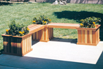 L-shaped planter bench has three square planters and two sections of bench space for the patio